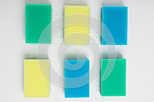 Cleaning, cleanliness, hygiene. Colored sponges on a white background