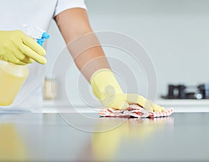 Cleaning, cloth and spray bottle with hands on person in gloves for kitchen disinfection or hygiene. Home, product and