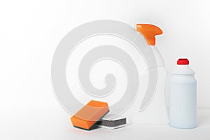 Cleaning company concept. Sponges and means for cleaning plumbing, sinks, bathtubs, toilet bowls in bottles on a white background