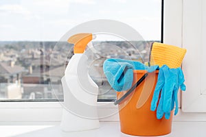 Cleaning company concept. Sponges, rags and a means for cleaning plumbing, sinks, bathtubs, toilet bowls in bottles on the window