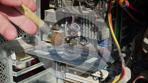 Cleaning computer from dust. Repairman cleans dusty parts