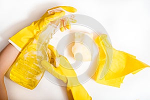 Cleaning concept - mixed detergents and cleaning accessories isolated on blue seamless background