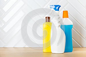Cleaning concept. Set of cleaning detergents in colored plastic bottles. Clean house