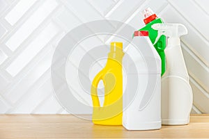 Cleaning concept. Set of cleaning detergents in colored plastic bottles. Clean house