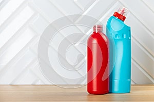 Cleaning concept. Set of cleaning detergents in colored plastic bottles. Clean house