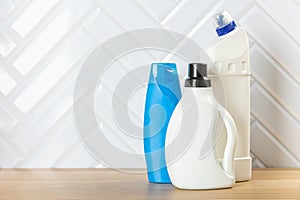 Cleaning concept. Set of cleaning detergents in colored plastic bottles. Clean house