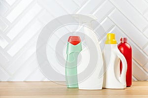 Cleaning concept. Set of cleaning detergents in colored plastic bottles. Clean house