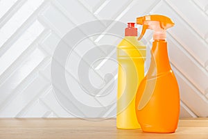 Cleaning concept. Set of cleaning detergents in colored plastic bottles. Clean house