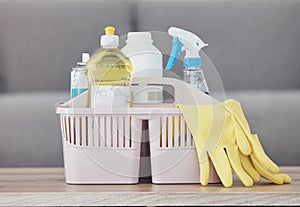 Cleaning container, spray bottle or rubber gloves on table in house, home or hotel living room for bacteria protection