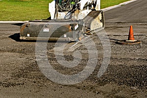 Cleaning debris during as asphalt repairs project