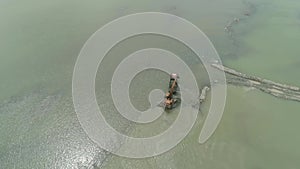 Cleaning and deepening by a dredger on the river. Philippines, Luzon