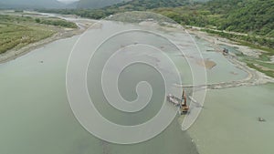 Cleaning and deepening by a dredger on the river. Philippines, Luzon