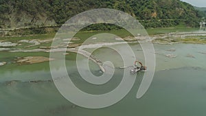 Cleaning and deepening by a dredger on the river. Philippines, Luzon