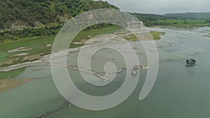 Cleaning and deepening by a dredger on the river. Philippines, Luzon