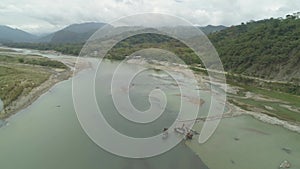 Cleaning and deepening by a dredger on the river. Philippines, Luzon