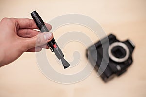 Cleaning digital camera with brush