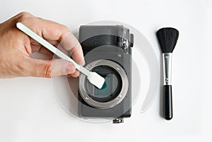 Cleaning digital SLR camera sensor with swab photo