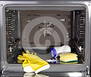 Cleaning a dirty oven. Gloves and oven cleaners