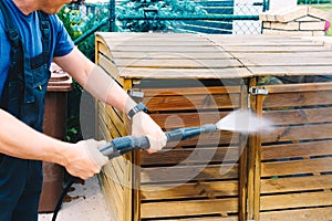 cleaning dirty wooden garden garbage with a high-pressure cleaner