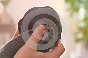 Cleaning DSLR lens with microfiber cloth
