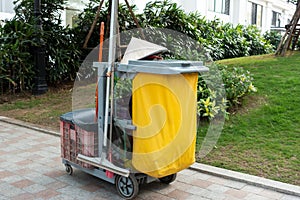Cleaning equipment cart in the hotel or aparment or high building with a conical hat in Vietnam street