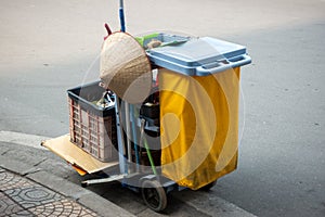 Cleaning equipment cart in the hotel or aparment or high building with a conical hat in Vietnam street