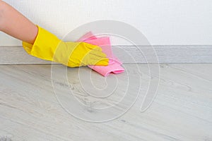 Cleaning floor in room close up. Woman cleaning parquet floor with rag at home. Housework and housekeeping concept