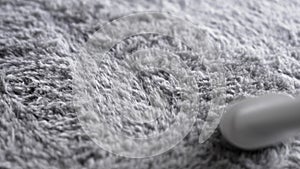 Cleaning grey carpet with white vacuum cleaner close up.