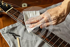 Cleaning guitar fretboard with wet wipes made for guitar