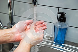 Cleaning hands with soap and hot water