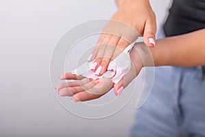 Cleaning hands with wet wipes, liht pink nails, prevention of infectious diseases, corona19