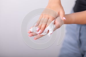 Cleaning hands with wet wipes, liht pink nails, prevention of infectious diseases, corona19