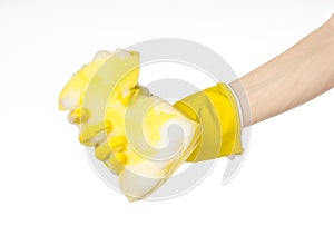 Cleaning the house and sanitation topic: Hand holding a yellow s