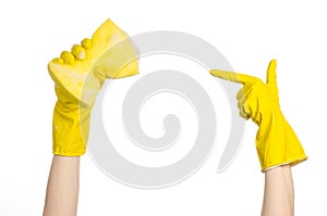 Cleaning the house and sanitation topic: Hand holding a yellow sponge wet with foam isolated on a white background in studio