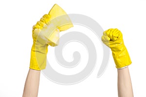 Cleaning the house and sanitation topic: Hand holding a yellow sponge wet with foam isolated on a white background in studio