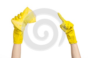 Cleaning the house and sanitation topic: Hand holding a yellow sponge wet with foam isolated on a white background in studio