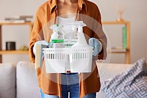 Cleaning, hygiene and detergent with a woman holding a basket of products as a cleaner in a home. Bacteria, container