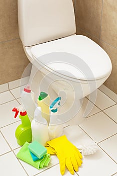 Cleaning items gloves brush white toilet bowl bathroom