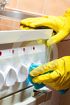 cleaning the kitchen - cleaning the stove, hands with a rag