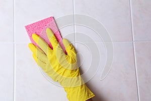 Cleaning kitchen tiles with a sponge