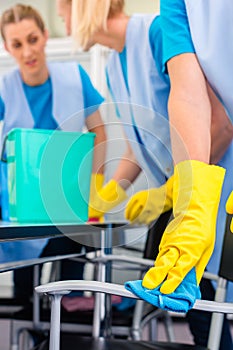 Cleaning ladies working as team in office