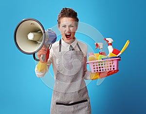 Cleaning lady with a basket with cleansers and brushes shouting