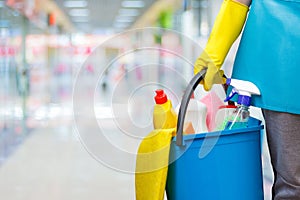 Cleaning lady with a bucket and cleaning products.