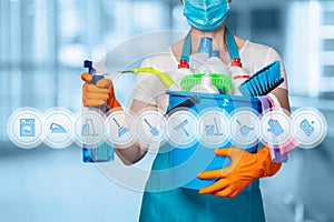 Cleaning lady with cleaning products on blurry background