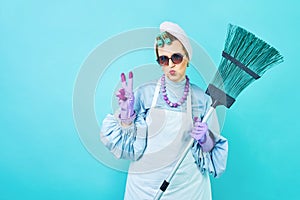 Cleaning Lady Fun. Elderly funny housewife fooling around with a broom. Full body  blue. Comical cleaning lady