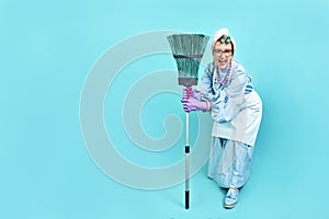 Cleaning Lady Fun. Elderly funny housewife fooling around with a broom. Full body. isolated