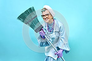 Cleaning Lady smile Fun. Elderly funny housewife fooling around with a broom. Full body 