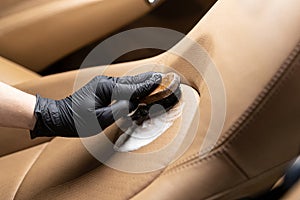 Cleaning leather car seat and upholstery with brush