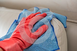 Cleaning leather sofa with blue cloth