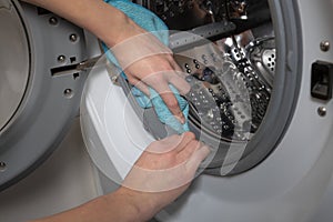 Cleaning and loading white washing machine